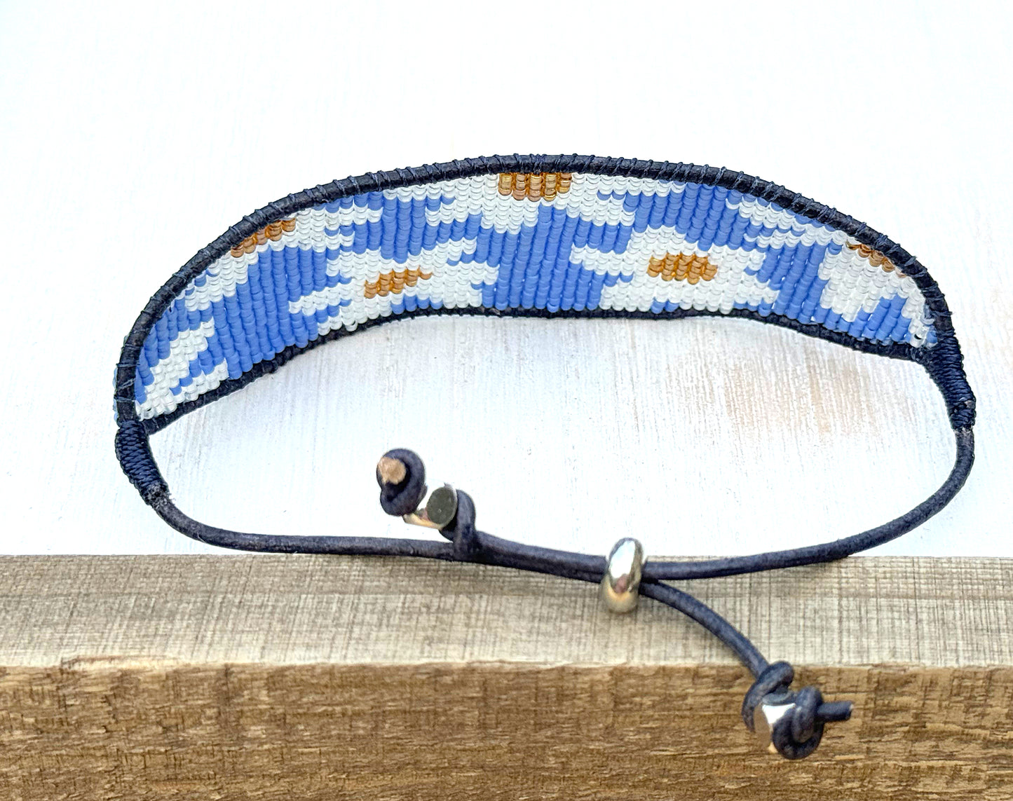 Blue and white boho flower bead loom woven bracelet with slide adjustment