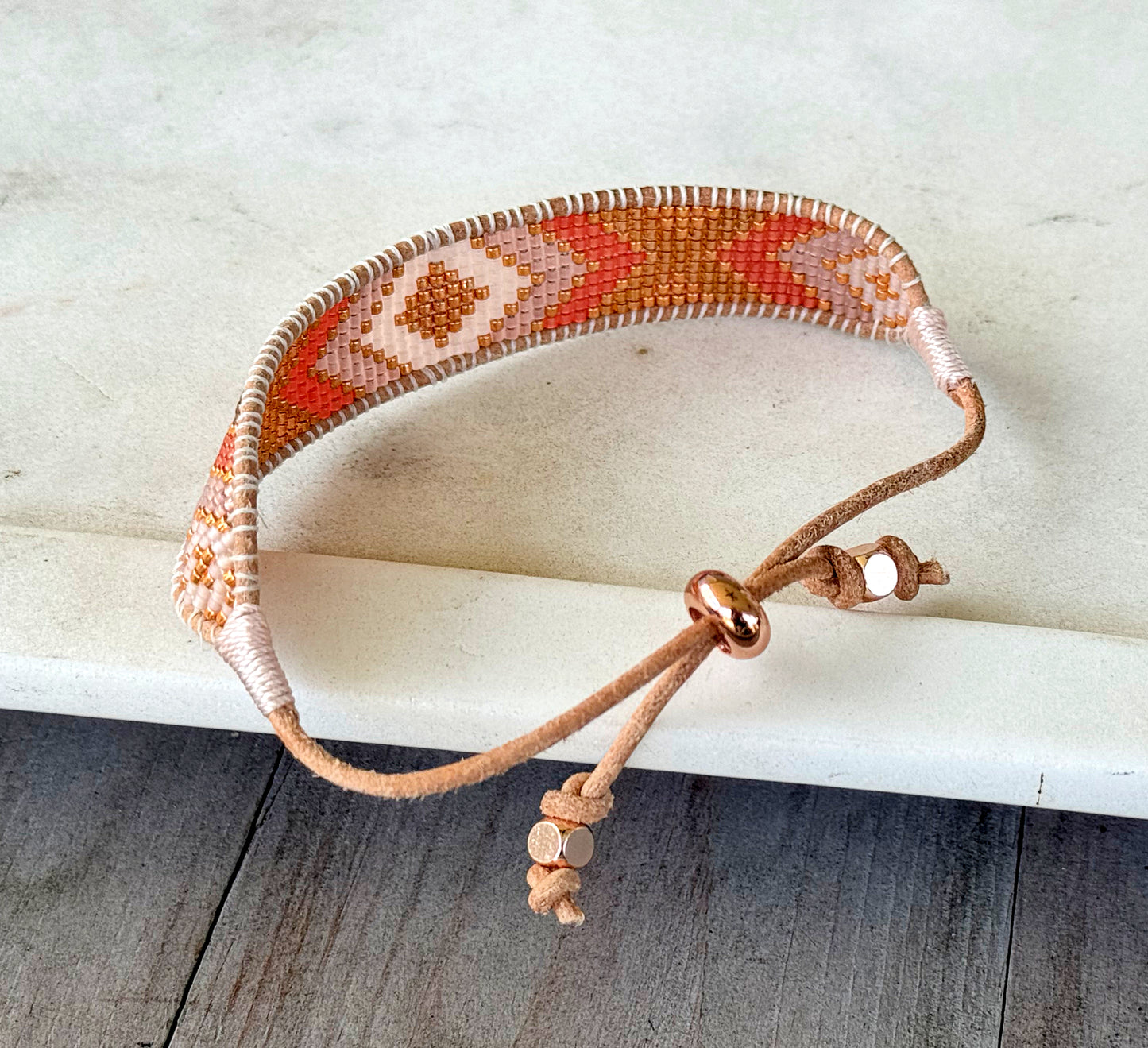 Peachy Coral and Tan Adjustable Bead Loom Woven bracelet with leather trim
