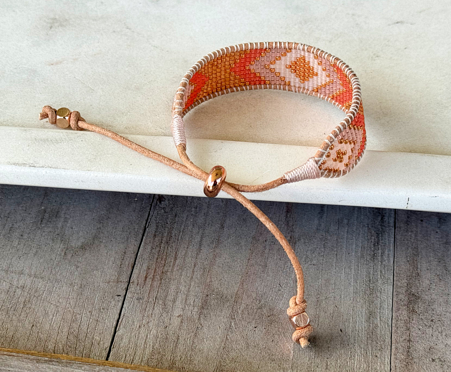 Peachy Coral and Tan Adjustable Bead Loom Woven bracelet with leather trim