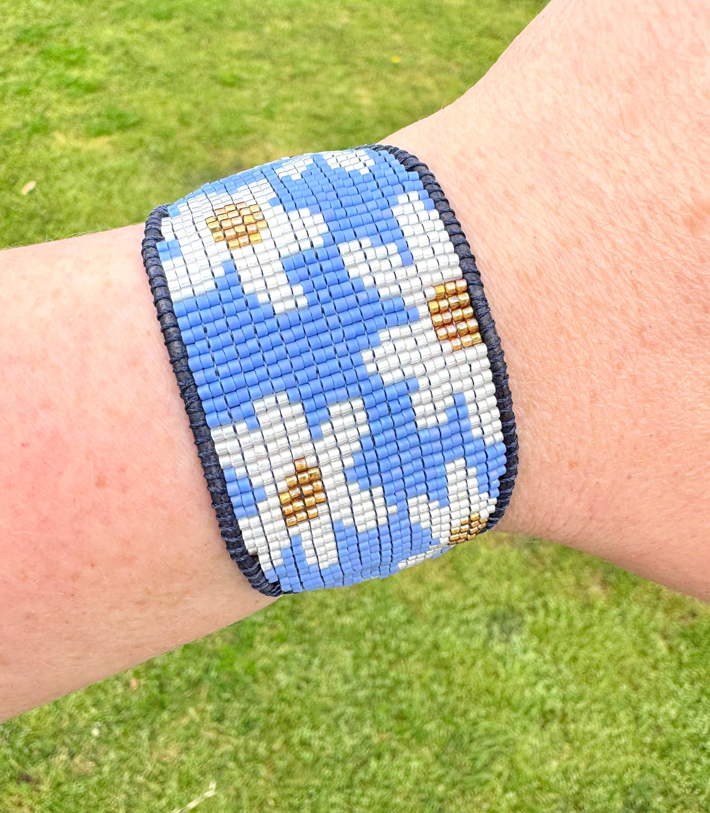 Blue and white boho flower bead loom woven bracelet with slide adjustment