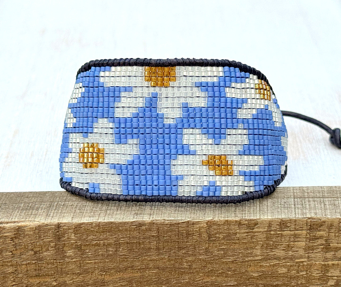 Blue and white boho flower bead loom woven bracelet with slide adjustment