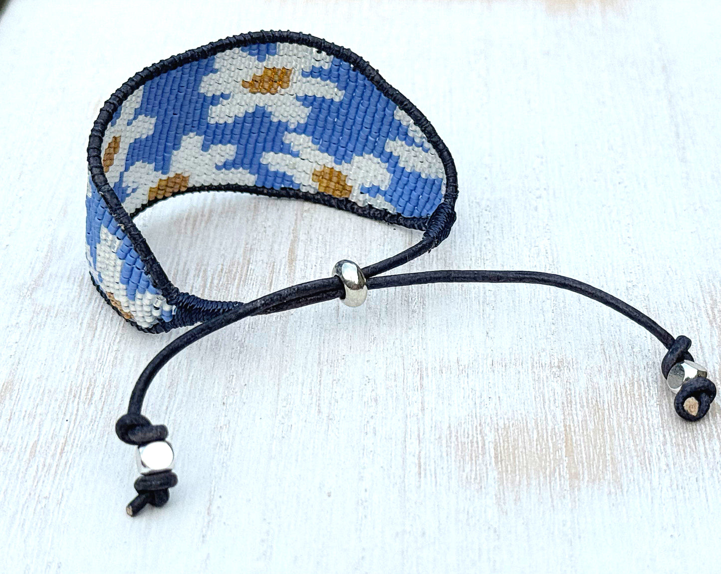 Blue and white boho flower bead loom woven bracelet with slide adjustment