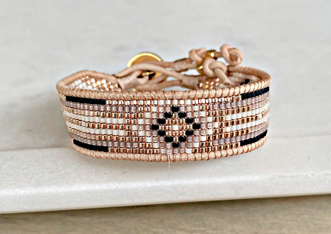 Gold, Beige, and Black Starburst Bead Loom Woven bracelet trimmed with leather