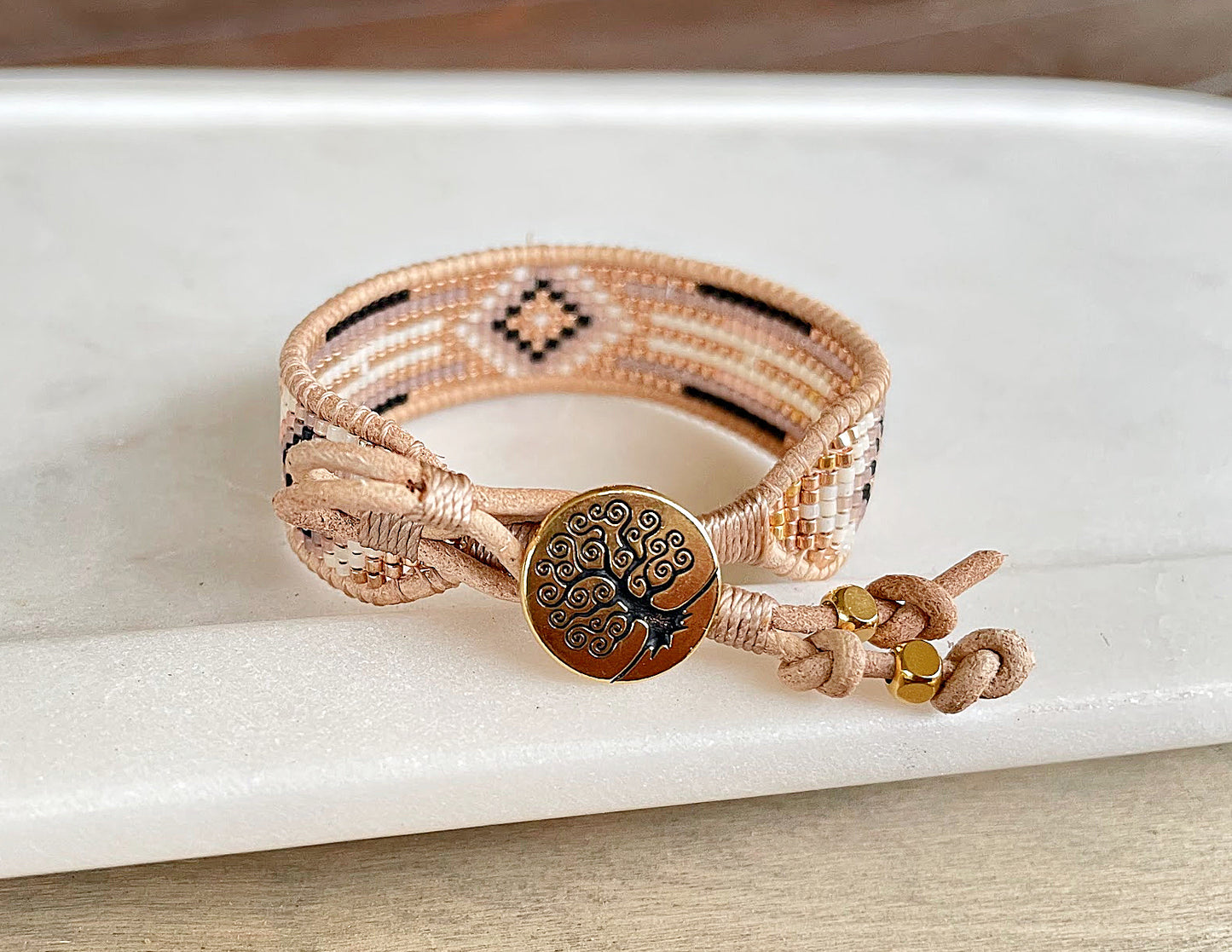 Gold, Honey Tan, and Black Starburst Bead Loom Woven bracelet trimmed with leather