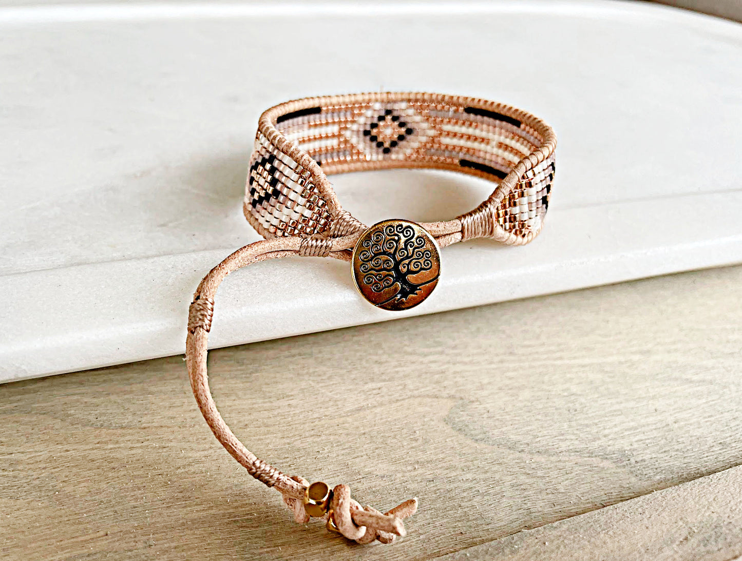 Gold, Honey Tan, and Black Starburst Bead Loom Woven bracelet trimmed with leather