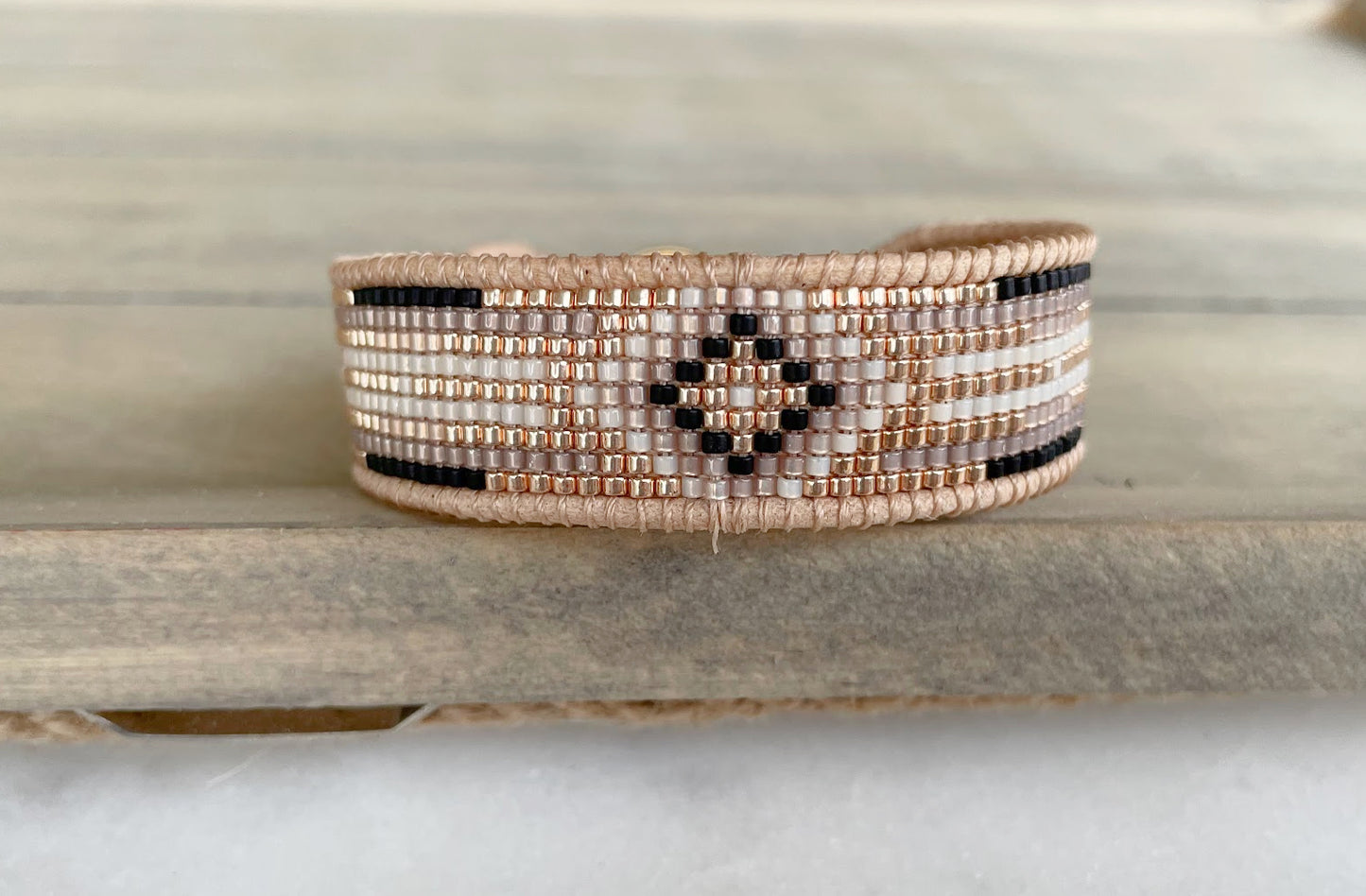 Gold, Beige, and Black Starburst Bead Loom Woven bracelet trimmed with leather