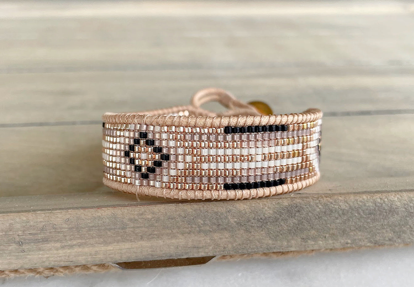 Gold, Beige, and Black Starburst Bead Loom Woven bracelet trimmed with leather