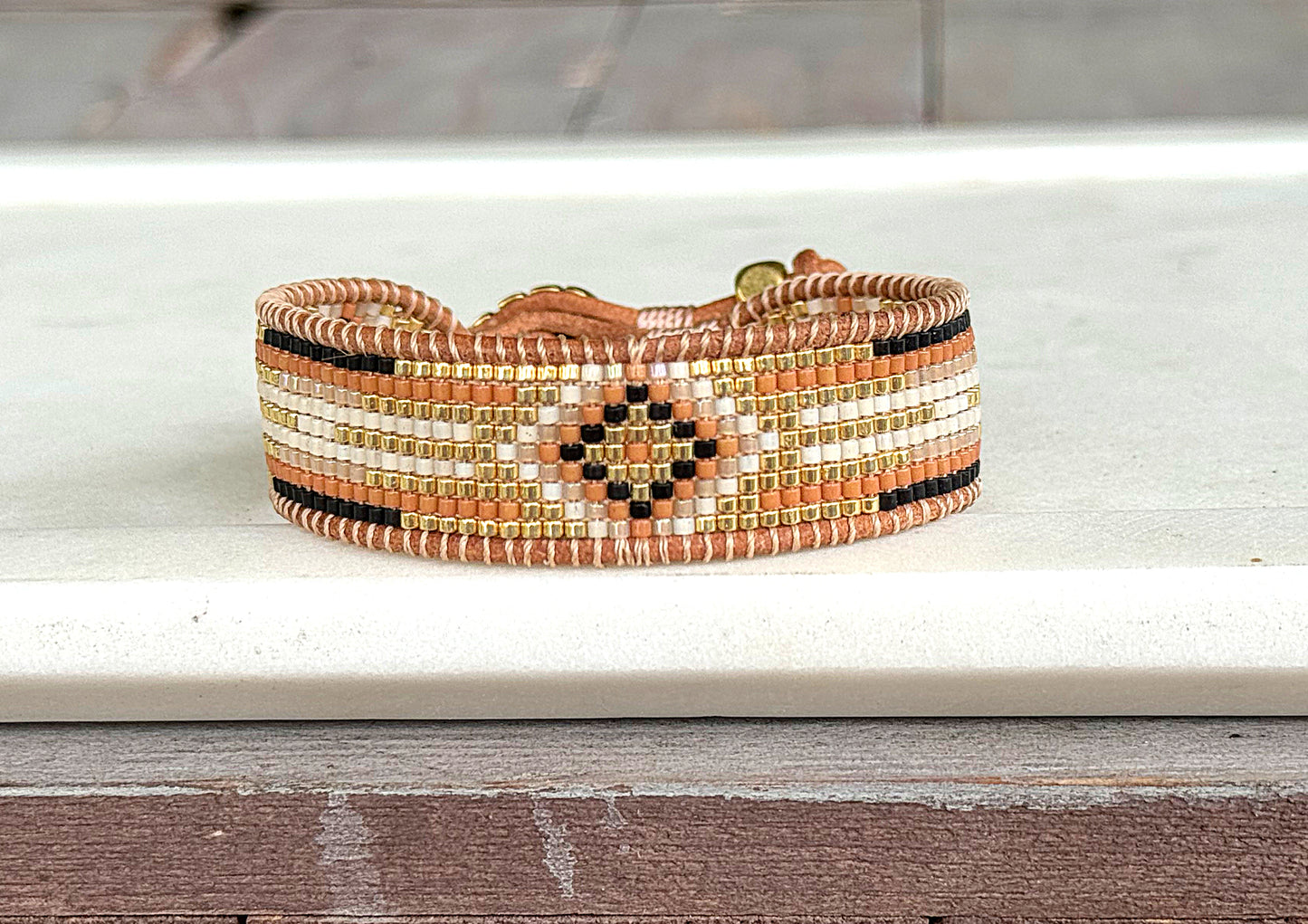 Gold, Honey Tan, and Black Starburst Bead Loom Woven bracelet trimmed with leather