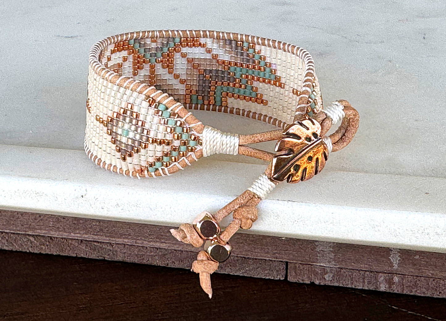 Sage, Ivory, Copper Starburst beaded loom woven bracelet trimmed with leather