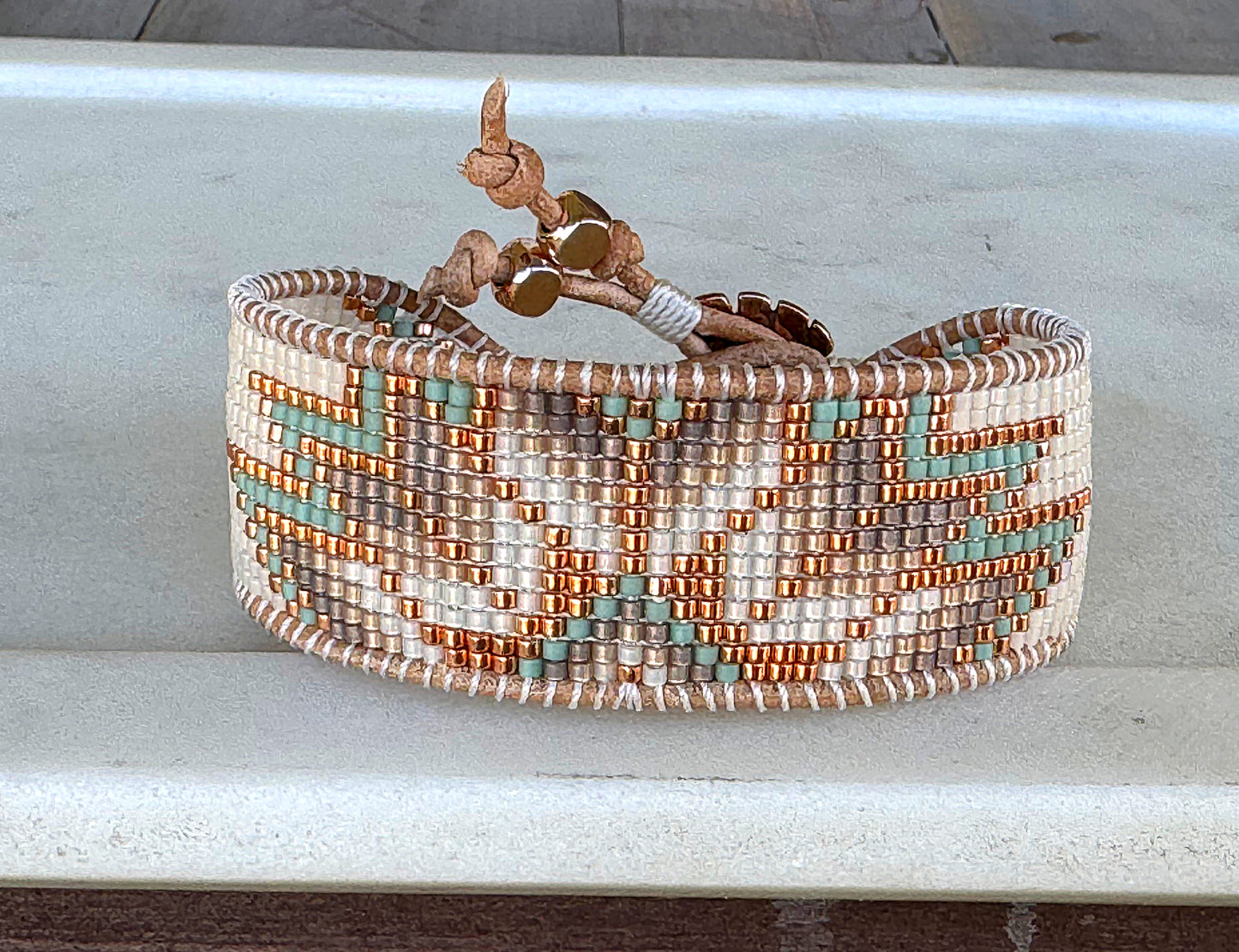 Sage, Ivory, Copper Starburst beaded loom woven bracelet trimmed with leather