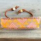 Sunshine, Peach Fuzz, and Coral Loom woven western beaded friendship bracelet