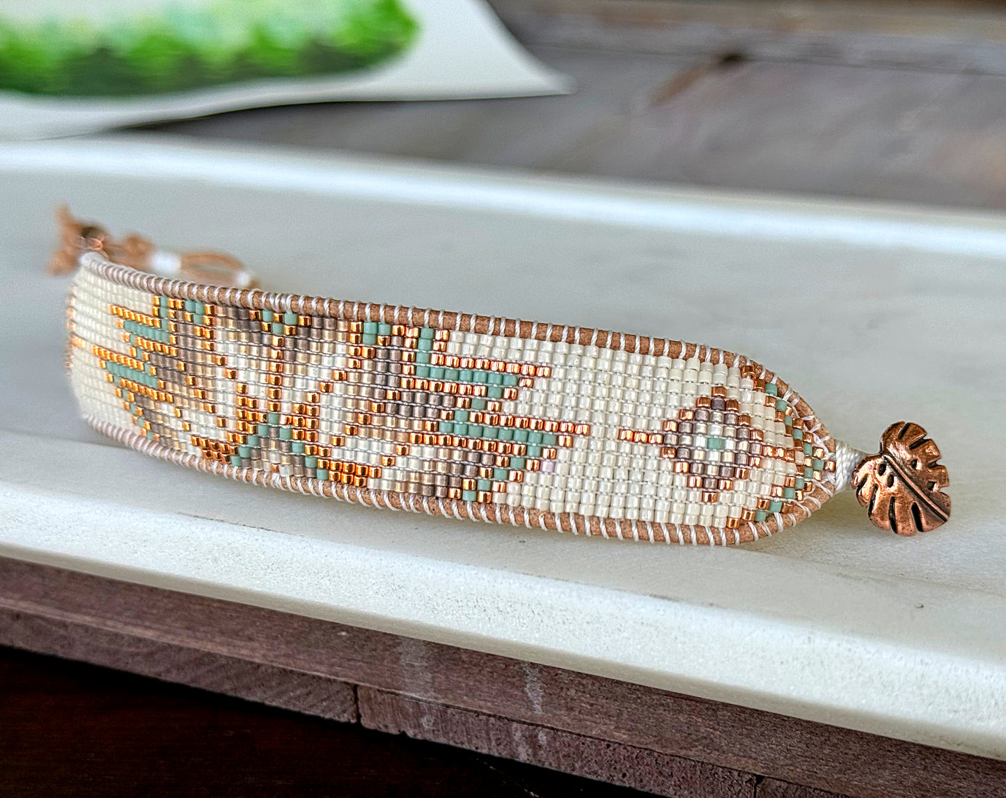 Sage, Ivory, Copper Starburst beaded loom woven bracelet trimmed with leather