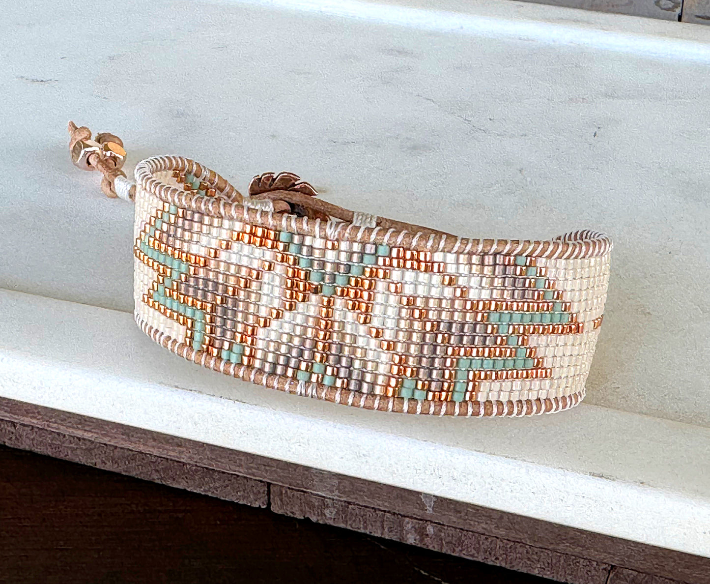 Sage, Ivory, Copper Starburst beaded loom woven bracelet trimmed with leather